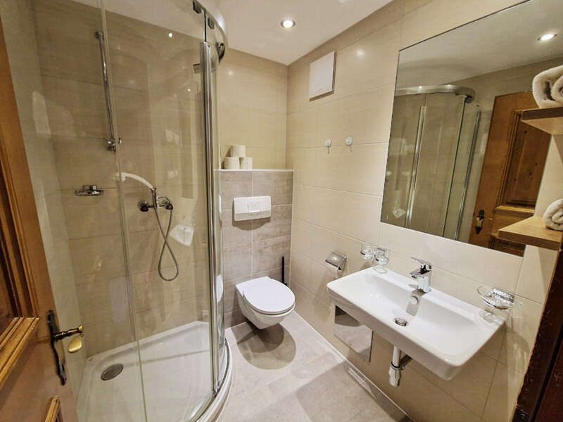 Bathroom with shower, washbasin and toilet