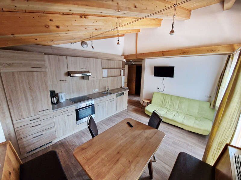 Living/dining area with kitchenette, sitting area, sofa and TV